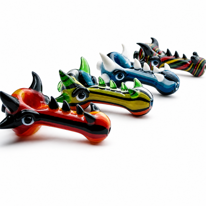 Four colorful dragon-shaped glass smoking pipes arranged diagonally on a clean white background.