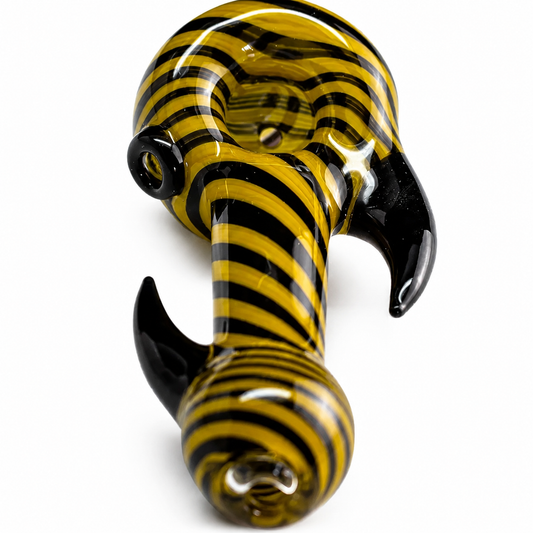 A glass water pipe with a bold yellow and black striped pattern and glossy black curved ends, shown on a plain white background.