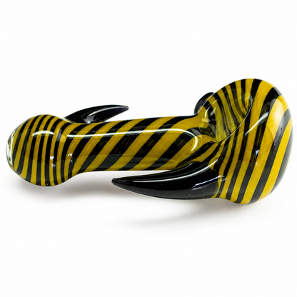 A glossy glass water pipe with a bold yellow and black striped pattern, photographed on a clean white background.